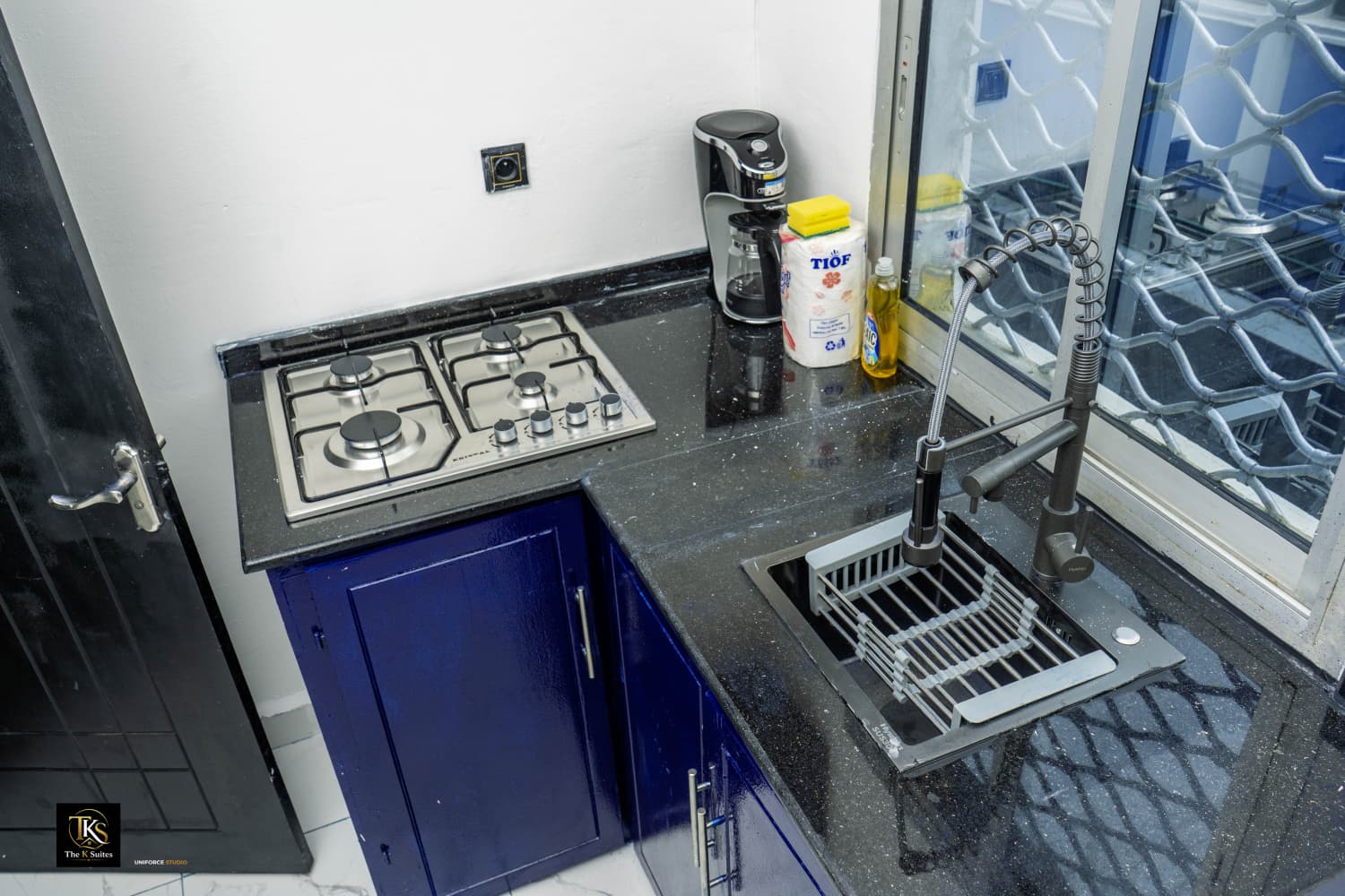 Kitchen — gas hob, coffee maker, modern sink